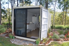 20' container modified with a glass sliding door and glass window